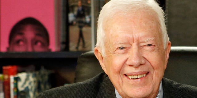 Former US President Jimmy Carter poses for a photo as he promotes his new book at Barnes & Noble, 5th Avenue on March 25, 2014 in New York City.
