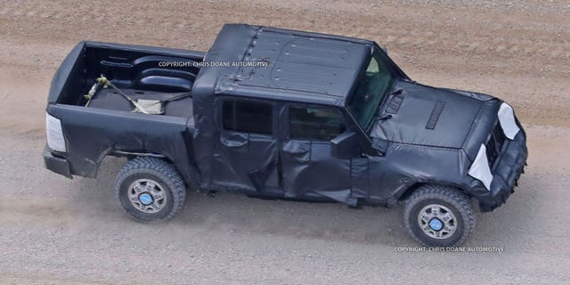 Camouflaged prototypes of the new Jeep pickup have been spotted being tested on public roads.