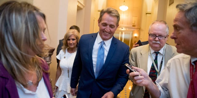Sen. Jeff Flake, R-Ariz., accompanied by his wife Cheryl, leaves the Capitol in Washington, Tuesday, Oct. 24, 2017, after announcing he won't seek re-election in 2018.
