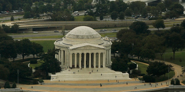 The Jefferson Memorial is surrounded by the Tidal Basin (bottom), and the Potomac River (top) in Washington October 1, 2014. Photograph taken from atop the Washington Monument. REUTERS/Gary Cameron (UNITED STATES) - RTR48Q3E