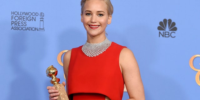 Jennifer Lawrence poses in the press room with the award for best performance by an actress in a motion picture - musical or comedy for Joy at the 73rd annual Golden Globe Awards on Sunday, Jan. 10, 2016, at the Beverly Hilton Hotel in Beverly Hills, Calif.