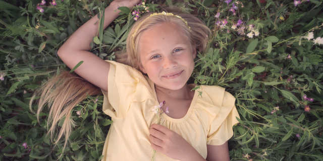 Lily Faith laying in the grass.