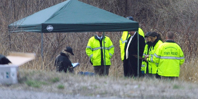 Massachusetts State Police stand along Interstate 190 where police found the body of 5-year-old Jeremiah Oliver, who was reported missing in December.