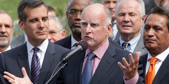 California Gov. Jerry Brown speaks at Los Angeles City Hall before signing the AB 60 bill in Los Angeles Thursday, Oct 3, 2013. The bill adds California to the growing list of states allowing immigrants in the country illegally to obtain driver licenses. (AP Photo/Nick Ut)