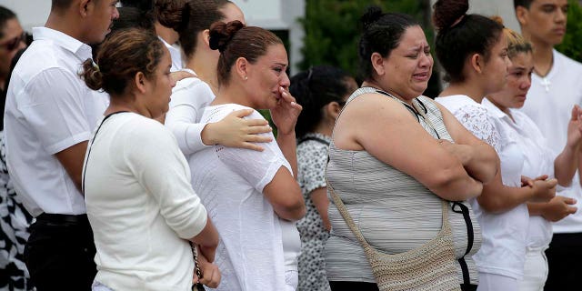Mourners gather outside a church in Union City, N.J., after a funeral for five children who were killed in a fire, July 25, 2018.