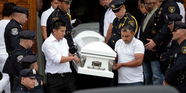 Five caskets are carried out of the church during a funeral for five children in Union City, N.J., Wednesday, July 25, 2018.