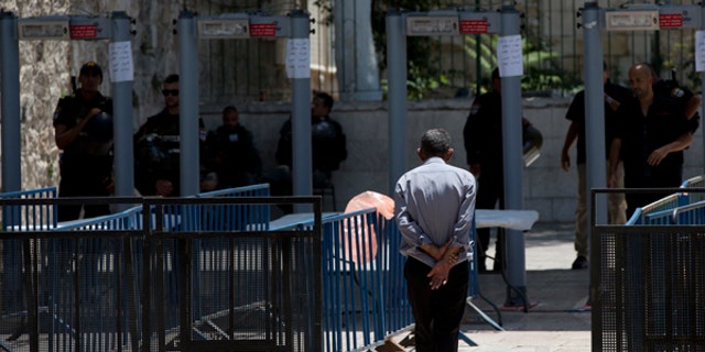 A Palestinian man walks towards a metal detector at the Al Aqsa Mosque compound in Jerusalem's Old City.