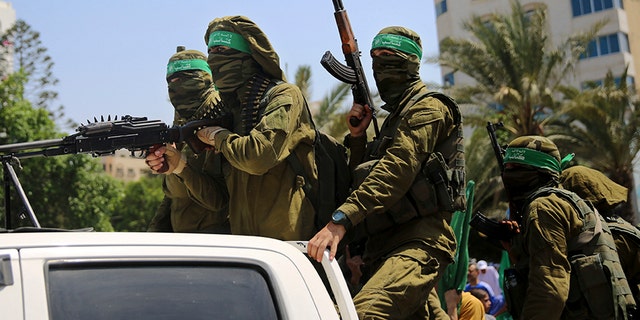 Masked militants from the Izzedine al-Qassam Brigades, a military wing of Hamas, ride vehicles during a protest against metal detectors Israel erected at the Al Aqsa Mosque compound in Jerusalem Friday.