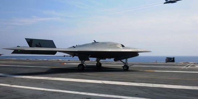 The U.S. Navy's unmanned X-47B lands aboard the USS Theodore Roosevelt.