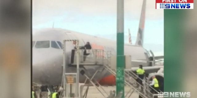 The man made it past crew after assaulting multiple Jetstar employees, then tried prying open the door to a Sydney-bound aircraft.