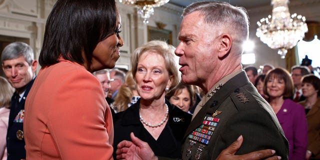 April 12, 2011: U.S. first lady Michelle Obama (L) talks with General James Amos (R) in the East Room at the White House.