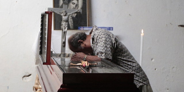 A man attends the wake of Miguel Angel Jimenez Blanco in Xaltianguis, Mexico, on August 9, 2015.