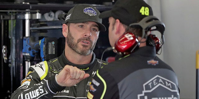 Jimmie Johnson talks with crew chief Chad Knaus during practice for the Daytona 500.