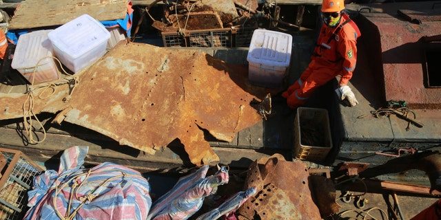 Workers transfer artifacts found from the long-lost warship Jingyuan in the sea area of Zhuanghe on September 25, 2018 in Dalian, Liaoning Province of China.