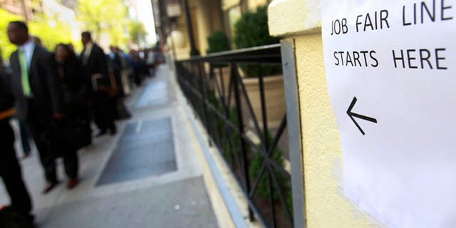April 18, 2012: People wait in line to enter a job fair in New York.