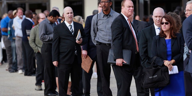 In this Oct. 7, 2014 photo, people wait in line to enter the Nassau County Mega Job Fair at Nassau Veterans Memorial Coliseum in Uniondale, New York.