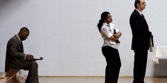 Job seekers wait in a line at a job fair in Southfield, Mich., Wednesday, June 15, 2011.