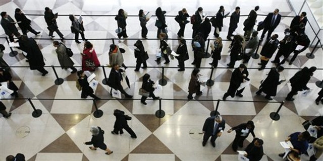 In this March 20, 2009, file photo, a line of job applicants is shown at the CUNY Big Apple Job Fair in New York.