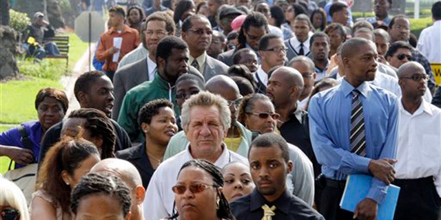In this Aug. 31 photo, crowds of job-seekers wait to enter a job fair at Crenshaw Christian Center in South Los Angeles.