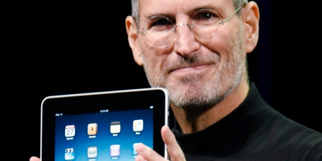 Jan. 27, 2010: Apple CEO Steve Jobs holds the new iPad during a product announcement in San Francisco.