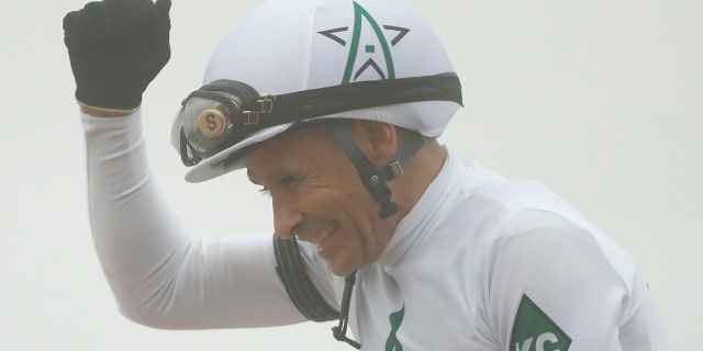 Jockey Mike Smith aboard Justify celebrates after winning the 143rd running Preakness Stakes at Pimlico Race Course.