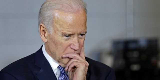 Feb. 25, 2015: Vice President Joe Biden listens to a student during a visit to robotic welding shop at the Manchester Community College in Manchester, N.H.