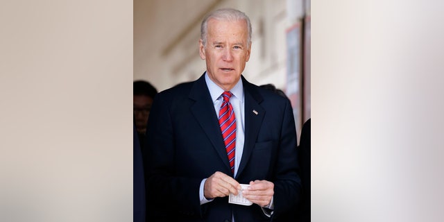 U.S. Vice President Joe Biden leaves after laying a wreath in front of the list of names of U.S. soldiers who died during the 1950-53 Korean War, at the Korean War Memorial Museum in Seoul, Dec. 7, 2013.