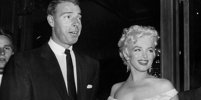 FILE - In this June 2, 1955 file photo, actress Marilyn Monroe, right, dressed in a glamorous evening gown, arrives with Joe DiMaggio at the theater. DiMaggio's love letter to Marilyn Monroe has sold for $78,125 at a Beverly Hills auction. Julien's Auctions in Beverly Hills says the letter, written by the baseball great after Monroe announced she was divorcing him, was sold Saturday, Dec. 6, 2014, to an undisclosed buyer.(AP Photo, File)