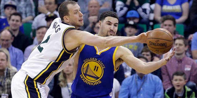 Utah Jazz forward Joe Ingles (2) defends against Golden State Warriors guard Klay Thompson (11) during the second quarter of an NBA basketball game Wednesday, March 30, 2016, in Salt Lake City. (AP Photo/Rick Bowmer)