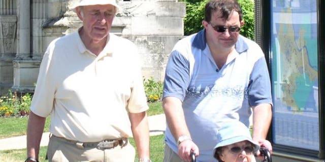 Robert Oliver is pictured here with his father, John, and mother, Betty, who died in 2012.