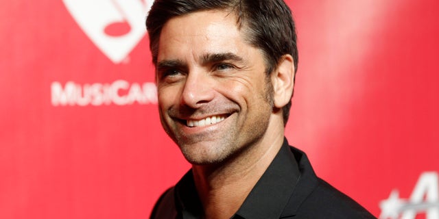 Feb 10, 2012. Actor and musician John Stamos poses at the 2012 MusiCares Person of the Year tribute honoring Paul McCartney in Los Angeles.