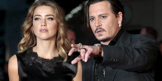 Cast member Johnny Depp and his actress wife Amber Heard arrive for the premiere of the British film "Black Mass" in London, Britain October 11, 2015. REUTERS/Suzanne Plunkett/Files TPX IMAGES OF THE DAY - RTSFY2G
