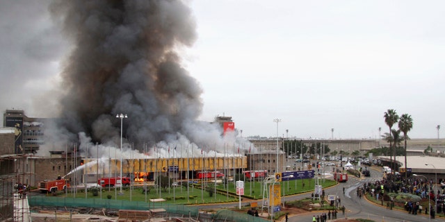 Aug. 7, 2013: Members of the public stand in front of the Jomo Kenyatta International Airport as it goes up in flames in Kenya's capital Nairobi.