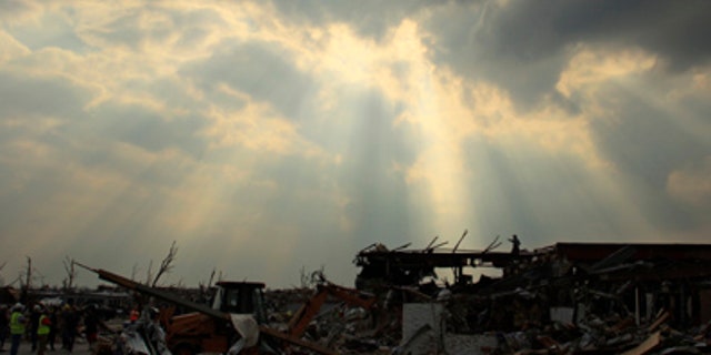 May 28: A search and rescue team surveys the area from atop the rubble of a destroyed building in Joplin, Mo. An EF-5 tornado tore through much of the city Sunday, damaging a hospital and hundreds of homes and businesses and killing at least 139 people. (AP)