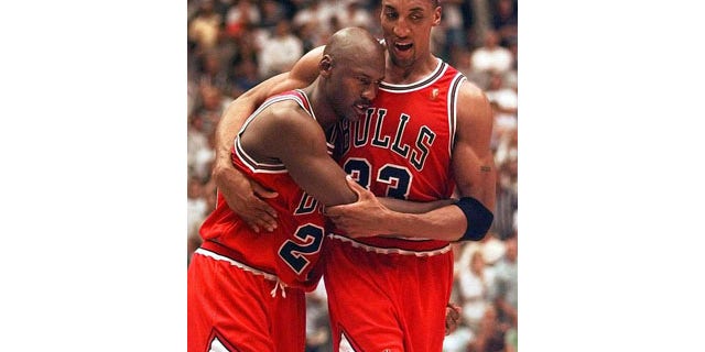 June 11, 1997: Scottie Pippen, right, helps Michael Jordan off the floor following Game 5 of the NBA Finals between the Chicago Bulls and Utah Jazz. Jordan scored 38 points in Chicago's 90-88 win despite playing with a severe stomach flu. (AP Photo)