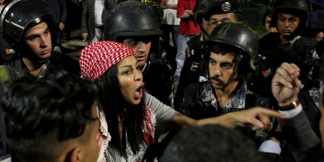 Jordanian protesters argue with members of the gendarmerie and security forces during a demonstration outside the Prime Minister's office in the capital Amman early Monday, June 4, 2018.