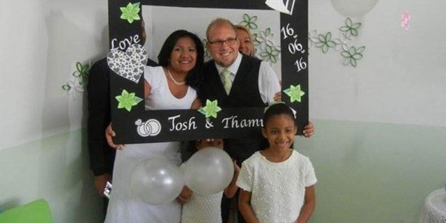 Joshua Holt and Thamara Candelo on their wedding day. Thamara's daughter, Nathalia, 7, is in the foreground.