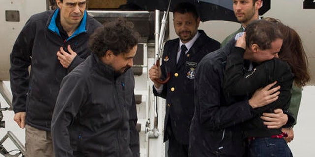 The three freed Spanish journalists Antonio Pampliega, right, Jose Manuel Lopez, left, and Angel Sastre, arrive at the Torrejon military airbase in Madrid, Spain. (POOL Moncloa, via AP)