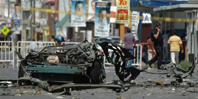 The remains of a vehicle are seen on a street in the northern border city of Ciudad Juarez, Mexico, July 16, 2010. (AP Photo)