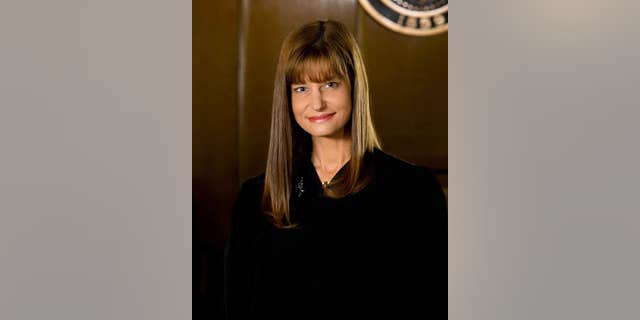 Judge Susie Norby said she offered to pay for courtroom damage she caused, but county officials said the cost was negligible.