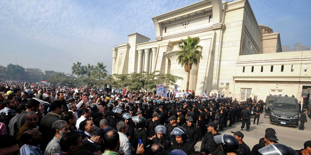 Dec. 2, 2012: Riot police form a cordon as several thousand supporters of Islamist President Mohammed Morsi surround the Supreme Constitutional Court on Sunday.