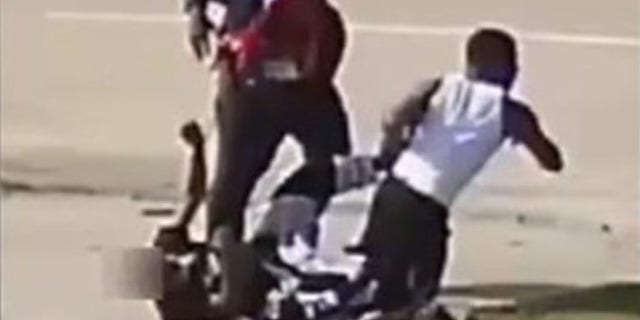 Authorities are searching for two men seen in a video attacking a man who had a bag of cash.