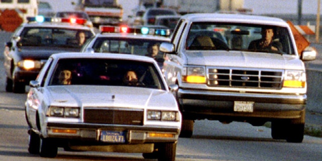 A Ford Bronco carrying O.J. Simpson (hidden in rear seat) is reportedly driven by Simpson's former teammate Al Cowlings, chased by dozens of police cars during an hour long pursuit through Los Angeles area freeways, June 17.