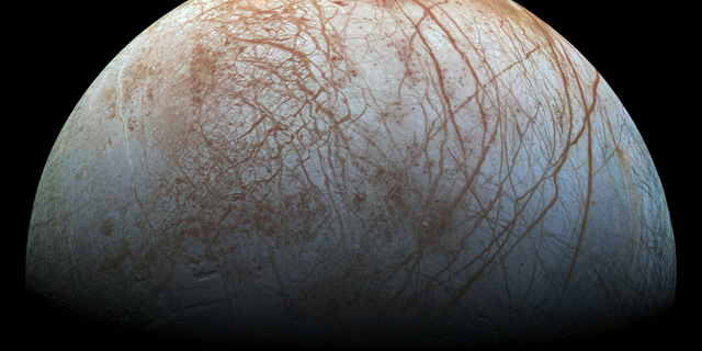 The frozen surface of Jupiter's icy moon Europa is seen in extreme detail in this remastered photo made from images taken by NASA's Galileo spacecraft in the late 1990s. A new study suggests that the ice on Europa may move between the moon's poles and its equator.