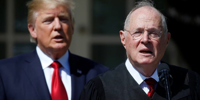 FILE: April 10, 2017: President Trump stands next to Supreme Court Justice Anthony Kennedy in the White House Rose Garden, in Washington, D.C.