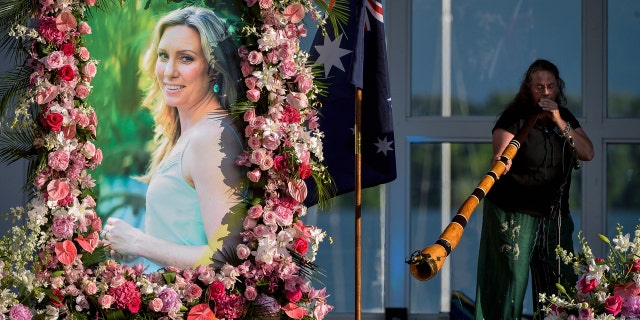 In this Aug. 11, 2017, file photo, Johanna Morrow plays the didgeridoo during a memorial service for Justine Damond in Minneapolis