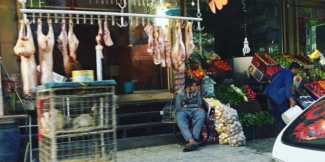 Marshal Azizi at an outdoor shop