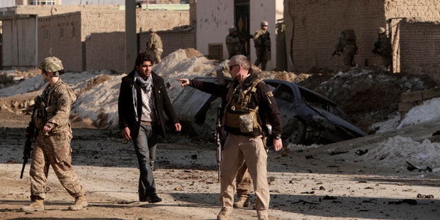 Feb. 10, 2014: U.S. soldiers secure the site where a suicide attacker rammed a car bomb into a NATO convoy in Kabul, Afghanistan.