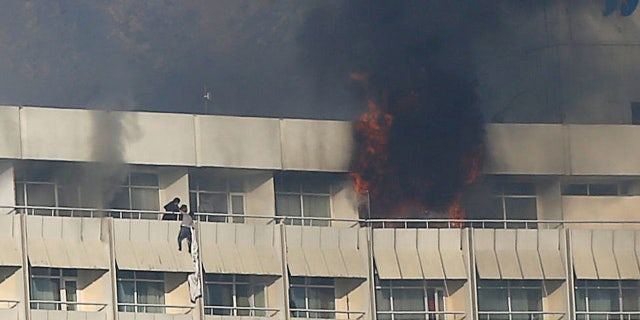 A man tries to escape from a balcony at Kabul's Intercontinental Hotel during an attack by gunmen in Kabul, Afghanistan January 21, 2018