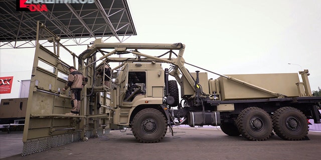 In this photo provided by the Kalashnikov company and made available on Tuesday, Aug. 29 2017, Russia's Kalashnikov company, the maker of the prolific assault rifle, present a formidable crowd control vehicle in Moscow on Friday, Aug. 23, 2017. The Shchit (Shield) vehicle is based on a heavy truck with a broad list of metal attached to its front. It is also equipped with a water cannon and offers protected positions for police officers. (Kalashnikov Company via AP)